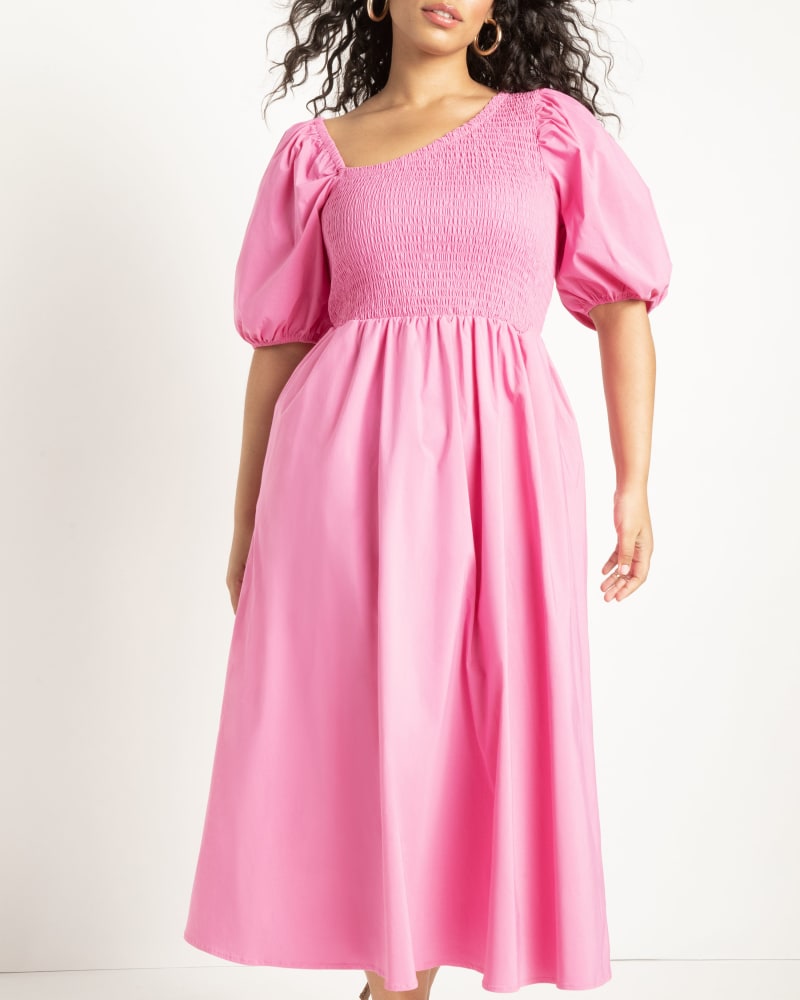 Front of a model wearing a size 18 Smocked Bodice Asym Neck Dress in Strawberry Moon by ELOQUII. | dia_product_style_image_id:300019